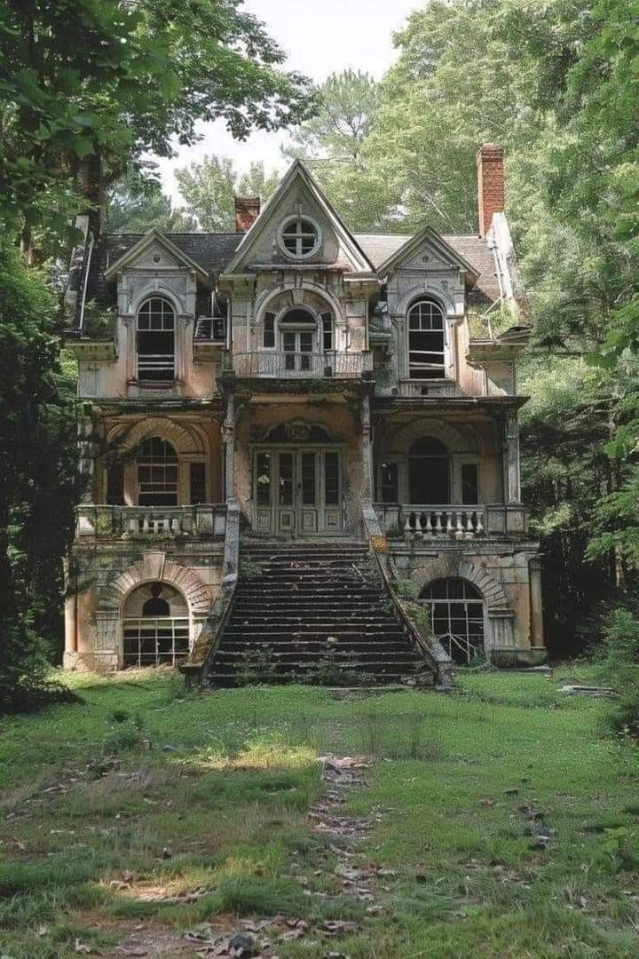 an old house in the woods with stairs leading up to it's second story