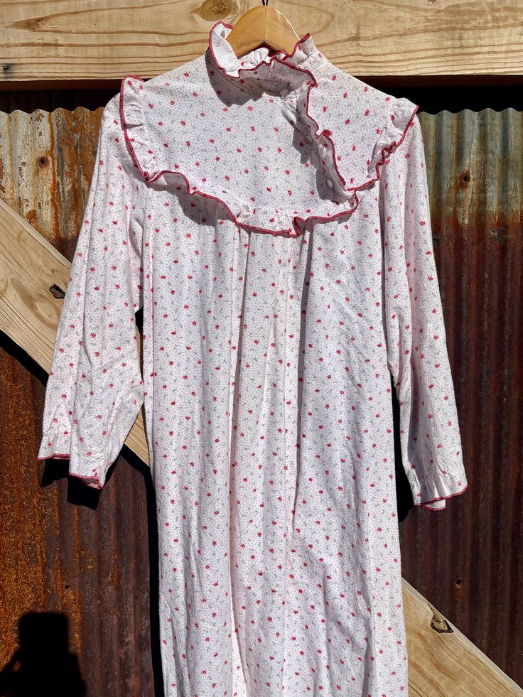 "Beautiful Victorian style flannel cotton nightgown/dress. This one is covered with dainty little purple & red flowers. High neck with ruffles that buttons up the neck 3 times to be exact. The ruffle tiered bottom is darling.  The elastic has been removed from the sleeves to give for a little more comfort but could be replaced if needed.  🌱 100% cotton by Cotton Club  Shown on a small  32 bust | 26 waist | 24 sleeves | 30 inseam  Measurements 📏  * 🏷️ 1  * 22\" ptp  * 26\" waist/ hips  * 50\" long  * 21\" sleeves" Style Flannel, Nightgown Dress, Cotton Club, Cotton Nightgown, Vintage Nightgown, Women's Nightgowns, Nightgowns, Victorian Style, Cotton Flannel