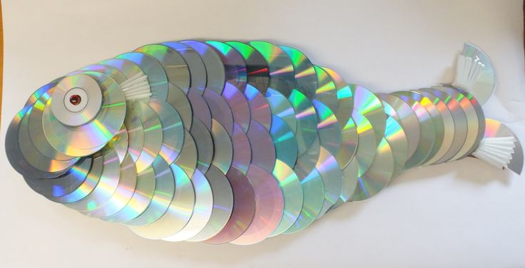 a fish made out of cds sitting on top of a table