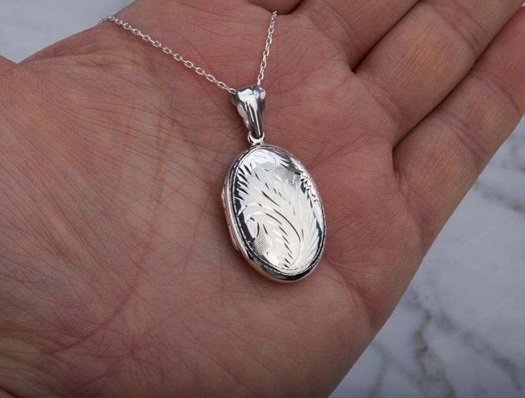 Carrying the pictures of your loved ones close to your heart all the time, this floral patterned locket features: 1. a solid sterling silver oval locket (30 x 21 mm, 6.25 grams) that can hold two pictures. The front and back cover has the same etched floral pattern. It surface cannot be further engraved. 2. a sterling silver cable chain with a lobster clasp. Upgrade to other type of chain available: https://www.etsy.com/listing/735520894 Packaged in my shop's premium gift box (as shown). TO ORDE Sterling Silver Locket Necklace Gift For Mom, Sterling Silver Locket Necklace For Mom, Elegant Silver Locket Necklace As Gift For Mom, Silver Pendant Locket Necklace Gift For Mom, Silver Pendant Locket Necklace As Gift For Mom, Silver Pendant Locket Necklace For Mom, Silver Locket Necklace With Birth Flower For Anniversary, Engraved Sterling Silver Locket Necklace For Mom, Silver Birth Flower Locket Necklace For Mother's Day