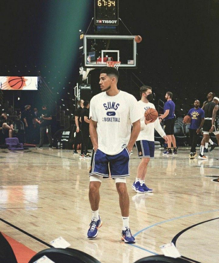 a man standing on top of a basketball court