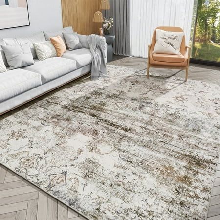 a living room with a large rug on the floor and a couch in front of it