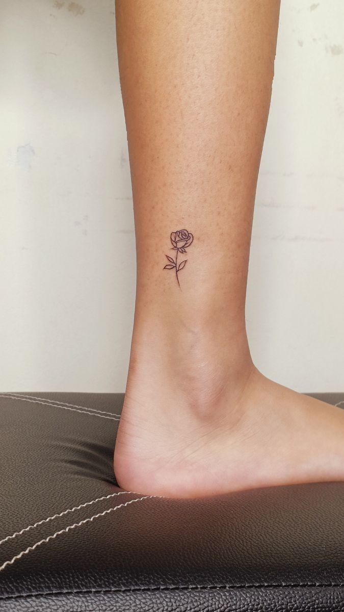 a small rose tattoo on the ankle