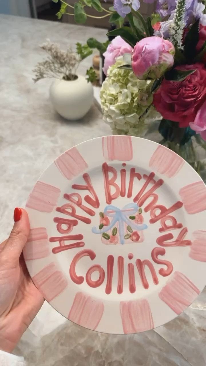 a plate with the words happy birthday collins on it and flowers in the background