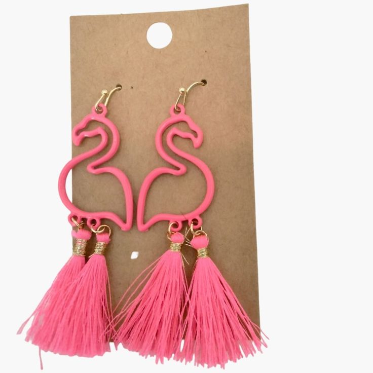 pink flamingo earrings with tassels hanging from it