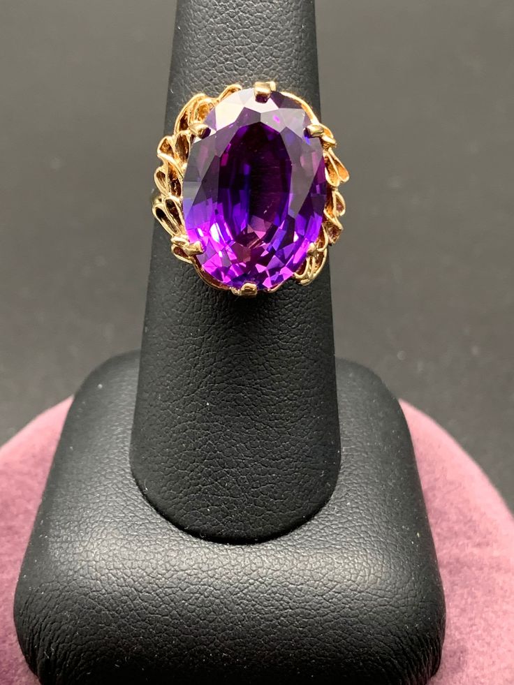 In  this 14k yellow gold ring the large color change lab created sapphire is the star! In daylight the gemstone is a true deep violet color but in incandescent light the color changes to more of a raspberry purple with even hints of blue. The other aspect of this ring that is exceptional is the intricate undercarriage that features a swirling scallop design that is truly beautiful. Created Sapphire: 18mm x 13mm  Ring size 7 Weight: 7 grams This ring has been inspected, cleaned, polished and is in excellent gift giving condition. It will ship fully insured in a presentation box. I want you to feel comfortable with your purchase, please feel free to convo me with any questions you may have. Each piece in my collection has been examined and professionally restored if it was needed. Buying and 14k Gold Purple Sapphire Ring With Accent Stones, Purple Sapphire Ring With 14k Gold Prong Setting, Oval Purple Sapphire Ring In 14k Gold, 18k Gold Bangle, Color Change Sapphire, Yellow Sapphire Rings, Kids Rings, Black Hills Gold, Turquoise Bracelet Cuff