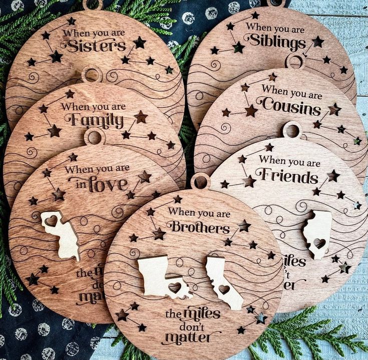 four wooden christmas ornaments with sayings on them