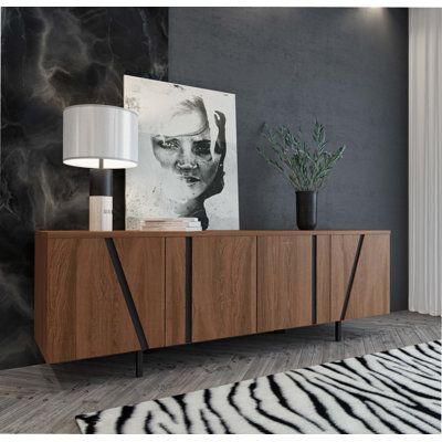 a zebra print rug in front of a modern sideboard with art on the wall