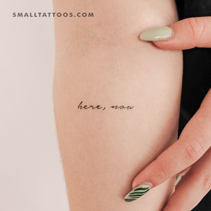 a woman's arm with the words here now tattooed on her left side ribcage