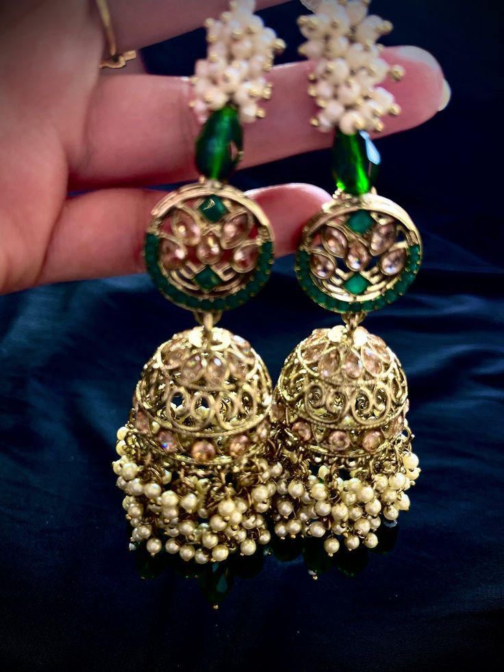 Alloy Based Necklace in gold color with forest green beads Enhanced with Stones, Beads and Artificial Pearls Adjustable cord to allow all size comfortable fit Set comes with with a matching pair of Earrings with chain , a Maang tikka and a passa Earrings have a push pin closure To view this set on head to our Instagram page @jyotikapateldesigns. You can also book a video call appointment with at +1 945-444-2194 Temple Jewelry Beaded Earrings For Parties, Traditional Green Tikka For Festive Occasions, Festive Green Tilla Tikka, Handmade Green Bohemian Jhumkas, Green Tikka With Latkans For Festivals, Traditional Green Tikka With Latkans, Green Bollywood Style Tikka For Festive Occasions, Green Bollywood Tikka For Festive Occasions, Festive Green Chandbalis For Party