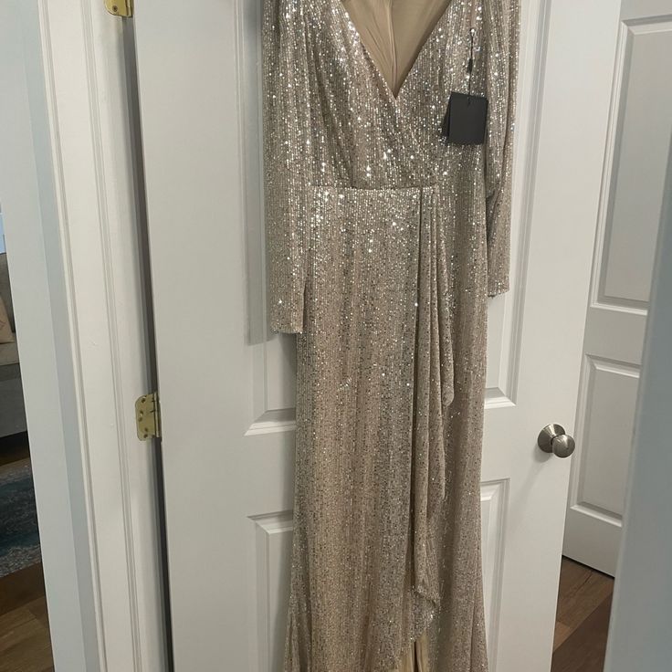 Mac Duggal Gold/Silver Formal Sequin Gown. Brand New With Tags. Size 10. Elegant Champagne Holiday Gown, Champagne Cocktail Gown, Silver Long Sleeve Dress For Prom, Glamorous Champagne Gown For Formal Occasions, Glamorous Champagne Formal Gown, Glamorous Holiday Wedding Maxi Dress, Champagne Holiday Evening Gown, Silver Long Sleeve Gown For Gala, Holiday Gala Floor-length Mother Of The Bride Dress