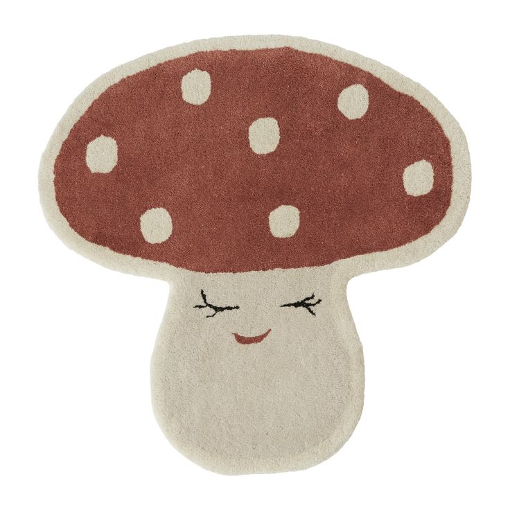 a mushroom rug with white dots on it