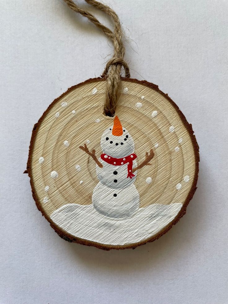 a wooden ornament with a snowman on it