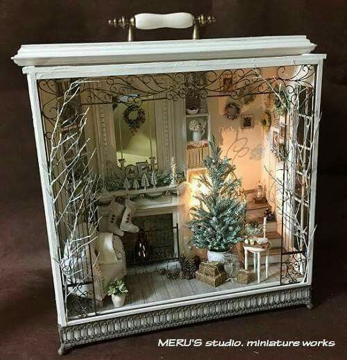 a miniature house with christmas trees in it