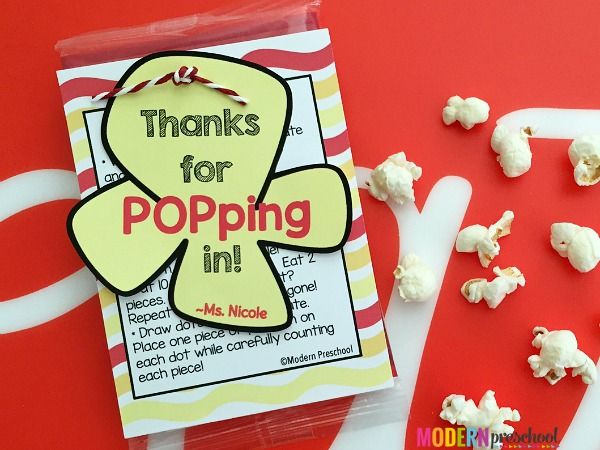 a bag of popcorn sitting on top of a table next to some candy sticks and other items