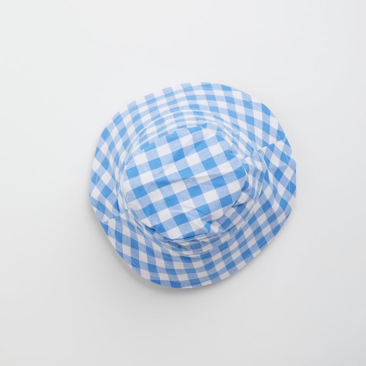 Introducing the Gingham Sunhat! Keep your little one looking stylish and shaded with this fun and fashionable cornflower blue baby sun hat, complete with checkered gingham print that your baby will love. Perfect for a day at the beach or a stylish stroll in the park. Shade in style! Fits ages 6 - 12 months Playful Blue Sun Hat For Summer, Playful Blue Wide Brim Sun Hat, Playful Blue Wide-brim Sun Hat, Playful Blue Sun Hat For Spring, Blue Summer Bucket Hat With Uv Protection, Summer Blue Bucket Hat With Uv Protection, Blue Bucket Hat With Uv Protection For Summer, Spring Blue Bucket Hat With Uv Protection, Playful Blue Bucket Hat