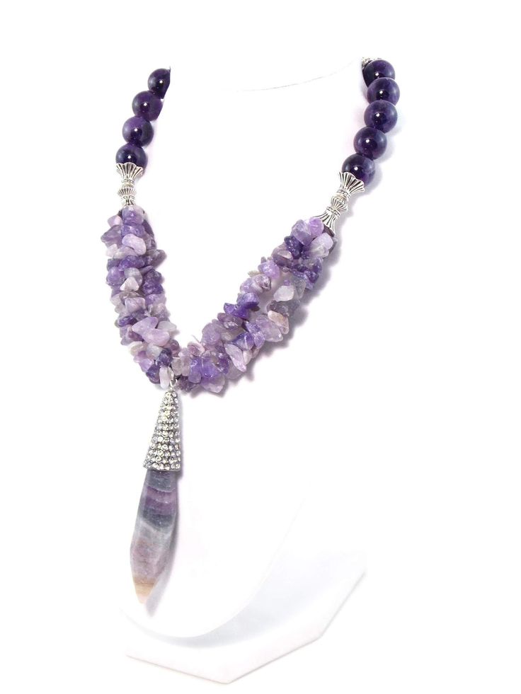 This stunning piece makes gorgeous statement! Semi precious Amethyst stones coupled with this beautiful semi precious crystal Fluorite pendant create an regal look with a rich luxurious feel! Silver plated accents add an elegant touch and help to complete the look! Necklace also includes extender chain so as to adjust Luxury Amethyst Jewel Necklaces, Luxury Amethyst Jewel Necklace, Luxury Amethyst Necklace With Jewels, Luxury Purple Necklace With Gemstone Beads, Luxury Purple Jewelry With Stones, Luxury Purple Stone Jewelry, Luxury Amethyst Necklaces With Natural Stones, Luxury Amethyst Pendant Jewelry, Luxury Amethyst Necklace With Natural Stones