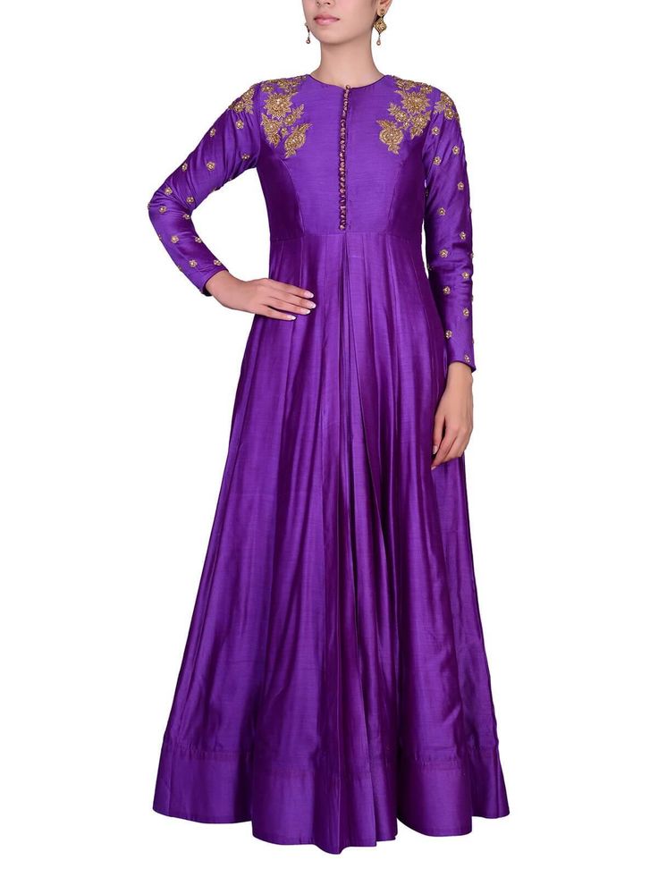 a woman wearing a purple long dress with gold embroiderys on the sleeves and neck