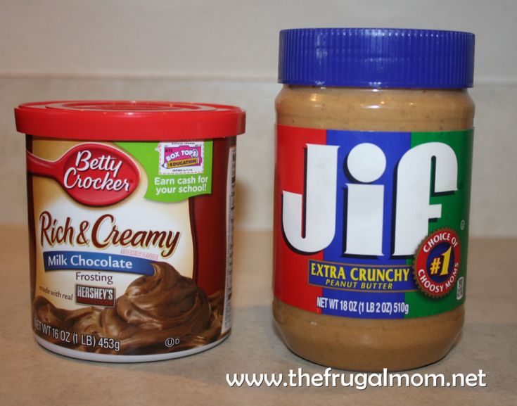 two jars of peanut butter and jelly creme are on the counter next to each other