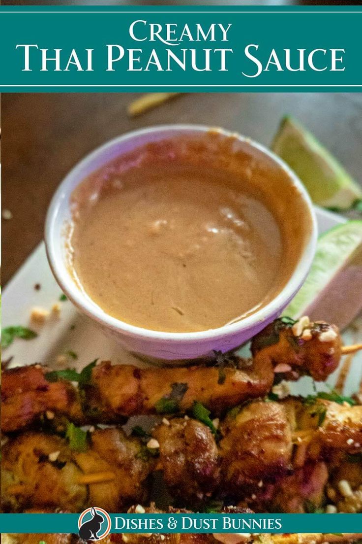 the cover of creamy thai peanut sauce on a plate with chicken skewers and dipping sauce