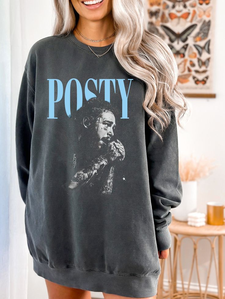 Get ready for your next country music festival with this cozy Post Sweatshirt. Perfect for fans of Post Malone, this hoodie combines style and comfort, making it a must-have for any concert-goer. Whether you're rocking out at a rap concert tour or enjoying a country music festival, this festival sweater will keep you warm and stylish. This design adds a unique touch, making it a standout piece for any fan. Ideal for layering during cooler festival nights, this Post Malone hoodie is the ultimate Outfit For Post Malone Concert, Graphic Print Hooded Top For Concert, Hooded Graphic Print Top For Concert, Oversized Winter Tops For Concerts, Oversized Tops For Winter Concert, Oversized Top For Winter Concert, Band Merch Sweatshirt For Winter Concerts, Hip Hop Cotton Hoodie For Concert, Cotton Hip Hop Hoodie For Concerts