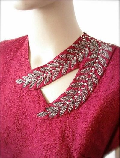 a close up of a mannequin wearing a pink dress with silver beading