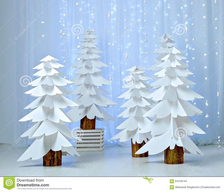 three paper christmas trees in front of a curtain