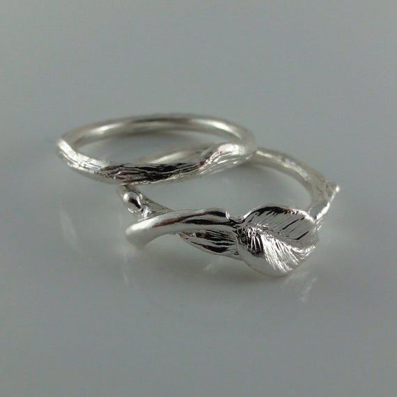 Hand sculpted Leaf & Twig Wedding Set with tiny buds and a leaf perfectly balanced on the Twig Ring.Couples RIngMade-to-Order, Please allow 3-4 weeks to ship. Materials: Sterling Silver (shown)Optional Materials: 14k Yellow, White & Rose GoldRing Size: Widest Point on Leaf Band: 6.5mm                   Twig Band Widest Point: 3mmAdditional Leaf & Twig Wedding Bands, Rings, Promise Rings as well as Bridal Gifts: https://www.etsy.com/shop/DawnVertreesJewelry?section_id=10707658&ref Minimalist Hand-cast Wedding Jewelry, Minimalist Hand Cast Wedding Jewelry, Nature-inspired Sterling Silver Wedding Rings, Nature-inspired Sterling Silver Wedding Jewelry, Minimalist Hand Cast Wedding Rings, Nature-inspired Sterling Silver Jewelry For Wedding, Nature-inspired Sterling Silver Jewelry For Weddings, Nature-inspired Sterling Silver Wedding Gift, Hand Cast White Gold Wedding Rings