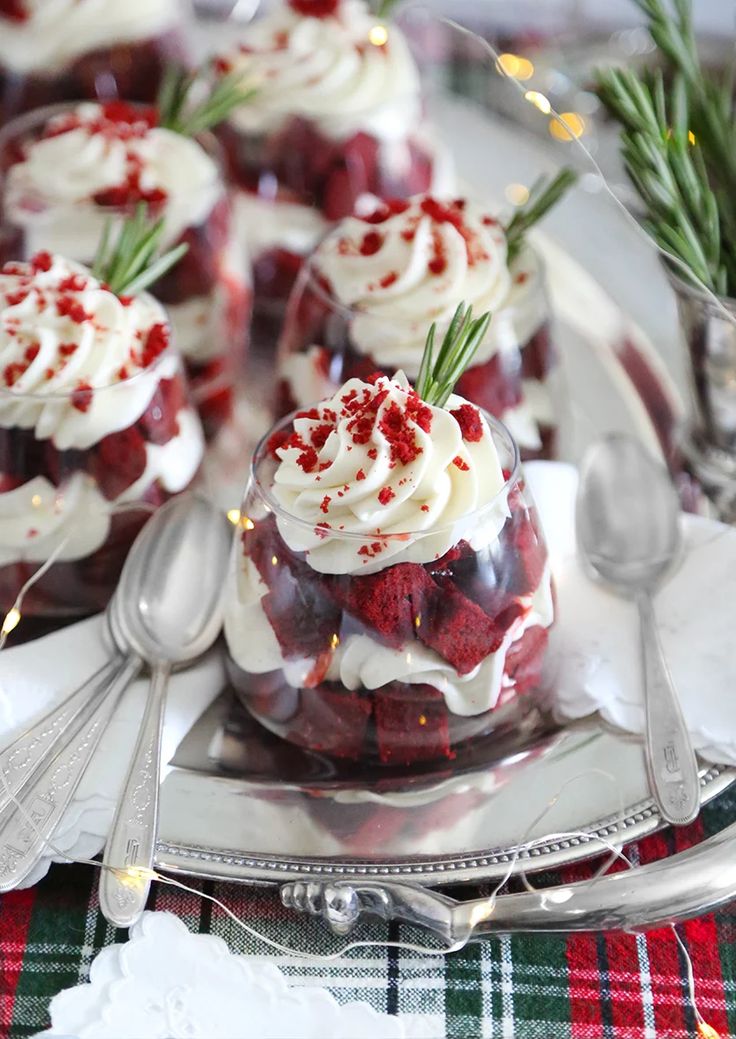 red velvet desserts with white frosting and sprinkles on a silver platter