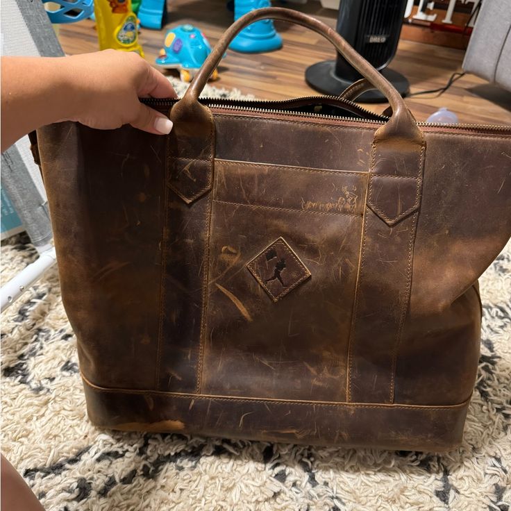 Baseballism Tote Bag Smoke Free Home Worn In But Still In Great Condition You Are Able To Use Lexi Leather Conditioner To Clean And Make The Purse Look Brand New Since It Is Made Of Vintage Baseball Glove Leather!! Dark Tan Leather Bag For On-the-go, Dark Tan Leather Crossbody Bag, Brown Duffle Bag With Removable Pouch For On-the-go, Brown Top Handle Travel Bag With Removable Pouch, Brown Tote Travel Bag For Daily Use, Distressed Brown Satchel Bag With Leather Lining, Brown Crossbody Travel Bag For On-the-go, Dark Tan Bags With Leather Lining For Everyday Use, Travel Shoulder Bag With Removable Pouch In Dark Tan