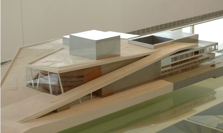 a model of a building made out of wood and glass on display in a museum