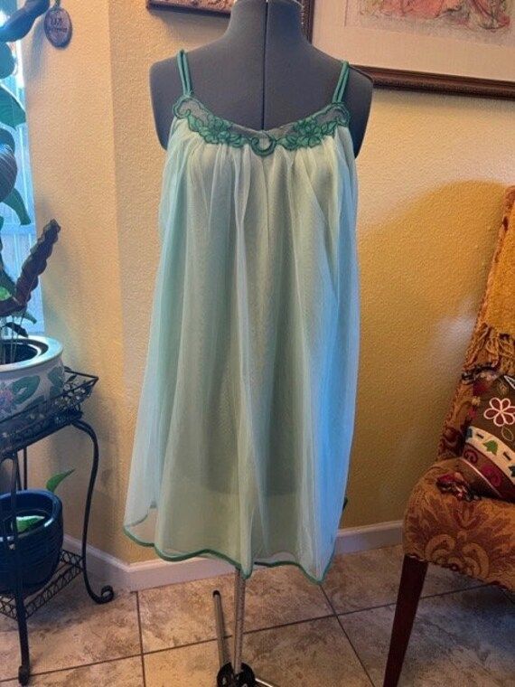 What a sweet little nighty for the summer evenings, mint green double layer nylon with shoulder straps and dark green floral design around the neck line, above the knee with green at the hem line Size Medium Measurements: Chest 17 1/2 laid flat across Length from armpit to hemline 25" Green Spring Sleepwear For Bedtime, Green Spring Sleepwear For Sleepover, Green Sleepwear For Spring Sleepover, Coquette Summer Nightgown For Sleep, Sheer Coquette Sleepwear For Summer, Summer Sleeveless Coquette Sleepwear, Green Sleeveless Sleep Camisole, Green Sleeveless Summer Sleepwear, Coquette Spaghetti Strap Nightgown For Summer