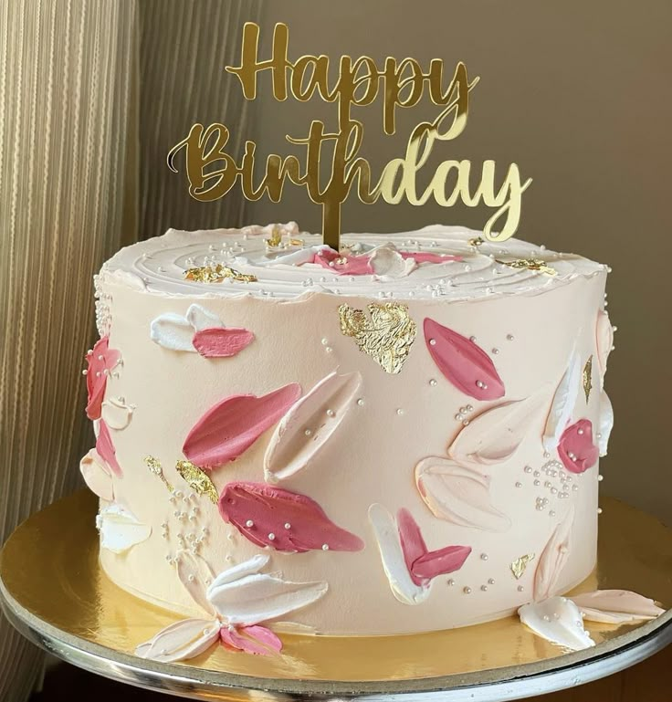 a birthday cake with pink and gold decorations