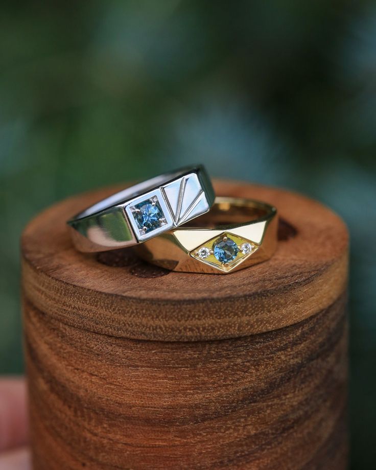 two rings sitting on top of a wooden box