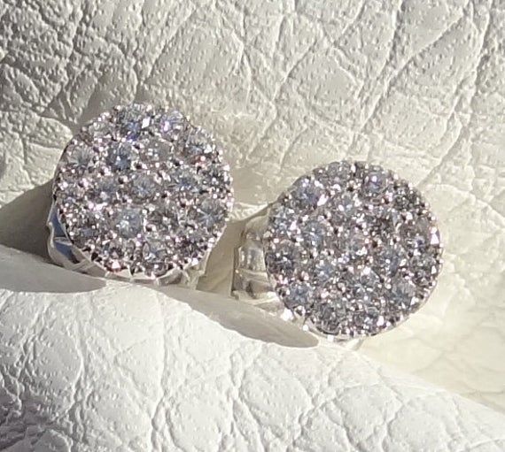 "You will LOVE these little stud earrings. They are classic and chic. They are very petite style earring. The entire earring is 7mm wide in diameter. The diamonds color is beautiful and rich. The earrings are made in 18k white gold. They are 7 mm wide. The posts are 10 mm long. The diamonds total carat weight is aprox. .40cts The friction backs are 14k white gold. The clarity of the diamonds is VS and color G range. The color combination of the bright white of the 18k white gold settings against Luxury Brilliant Cut Cluster Earrings For Anniversary, Luxury Cluster Diamond Earrings For Anniversary, Luxury Diamond White Cluster Earrings For Anniversary, Luxury Round Cut Cluster Earrings For Anniversary, Luxury Hallmarked Diamond Earrings For Anniversary, Luxury Cluster Earrings For Anniversary, Luxury Brilliant Cut Cluster Earrings As Gift, Luxury Cluster Earrings With Brilliant Cut For Gifts, Luxury Diamond Accented Cluster Earrings For Anniversary