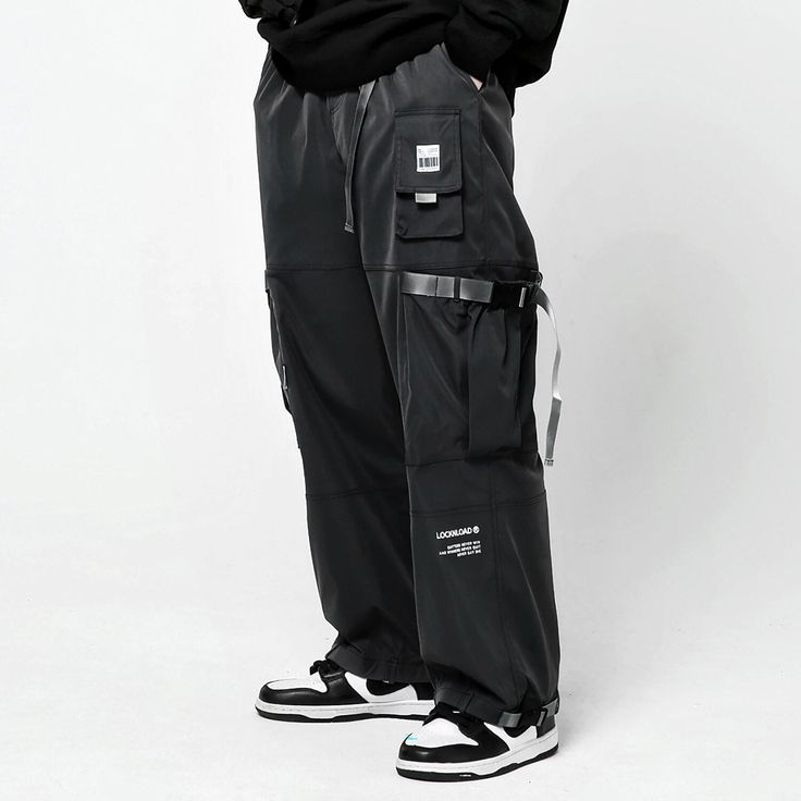 Loose streetwear reinvented: discover our unique baggy joggers. Unveiling the Streetwear Baggy Pants, a daring reinterpretation of classic urban style meticulously tailored for the modern city explorer. Envision the power and confidence you embody as you navigate the dynamic urban landscape, the energy of the city mirroring your own. These oversized, straight-fit cargo pants don't merely boost your daily elegance - they amplify your innate audacity, positioning you at the forefront of contemporary fashion. Adorned in these multifunctional black streetwear joggers, you seamlessly become a part of the city's pulsating heart. The pants' versatility seamlessly matches any streetwear accessory, bestowing you the command over your look, and letting you set the pace of urban fashion trends. Delvi Loose Streetwear, Baggy Joggers, Streetwear Joggers, Apocalyptic Clothing, Techwear Pants, Techwear Outfits, Black Streetwear, Urban Sophistication, Urban Fashion Trends