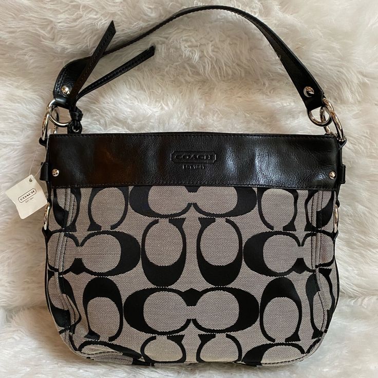 Nwt Coach Signature Zoe Shoulder Bag F14708 Msrp $348 Sv/Black / White/Black Features: Zipper Department: Women Strap Drop: 7" Pattern: Jacquard Look: Hobo Lining Material: Leather Bag Height: 10" Size: Medium To Large Country/Region Of Manufacture: China Material: Leather Style Subtype: Hobo Bag Length: 13" Texture: Jacquard Bag Depth: 3.5" Brand: Coach Style: Hobo Color: Black With Silver Hardware Closure: Zipper Follow Me On Insta Joy_closet4u Selling My Authentic Brand New/ Unused Collection Gray Shoulder Bag With Handles For Evening, Formal Black Coated Canvas Shoulder Bag, Elegant Gray Shoulder Bag, Black Shoulder Bag With Leather Handles And Coated Canvas, Evening Gray Shoulder Bag With Handles, Black Top Handle Shoulder Bag In Coated Canvas, Classic Shoulder Bag With Gunmetal Hardware, Black Coated Canvas Shoulder Bag With Leather Handles, Black Coated Canvas Shoulder Bag With Branded Hardware