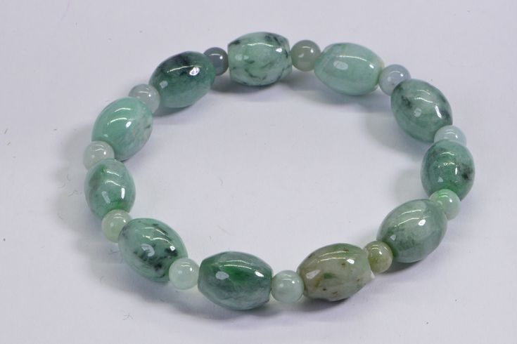 Genuine Burmese Jade Bracelet Light green to dark green smooth, shiny finished. beaded on stretch cord for more durable, I did double circle. Size bracelet 7.5 inch Jade barrel 12X8mm , round 5mm Your bracelet come in gift box. On picture exactly bracelet you will receive Green Adjustable Beaded Bracelets With Oval Beads, Green Stretch Bracelet With Faceted Round Beads, Green Oval Beads Bracelet As A Gift, Casual Green Stretch Bracelet With Large Beads, Green Jade Stretch Bracelet With Round Beads, Green Stretch Bracelet With Polished Round Beads, Green Stretch Bracelet With Polished Beads, Spiritual Green Stretch Bracelet With Polished Beads, Burmese Jade