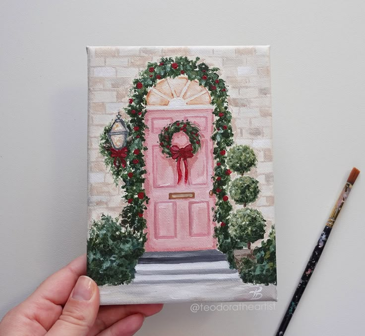 a painting of a pink door with wreaths on it and a pencil next to it