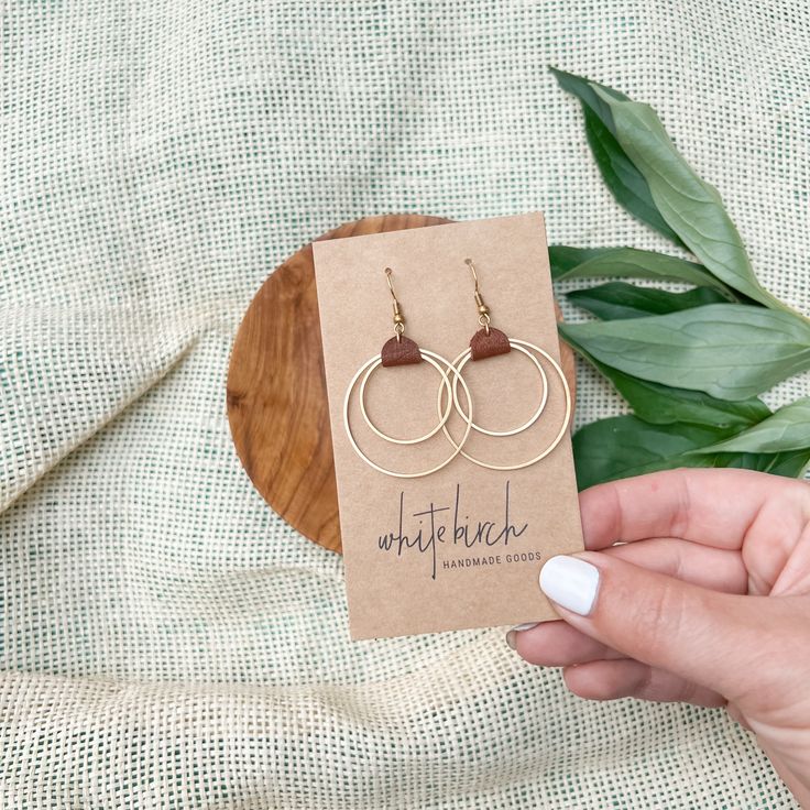 We had so much fun creating the original pair, so we decided to make a smaller version of one of our best selling designs! Having a cute pair of earrings, like these rich brown leather & brass circles earrings is a necessity! ••••••••••••••••••••••••••••••••••••••••••••••••••••••••••••••• ORDERING •These leather earrings measure approx 1 3/8" wide, 2 1/8" drop with hook.These earrings feature raw brass accents. Please note raw brass will naturally oxidize over time, creating a beautiful vintage Adjustable Drop Earrings For Everyday Use, Brown Hoop Earrings Gift, Modern Small Hoop Brown Earrings, Handmade Brown Hoop Earrings For Everyday Wear, Leather Dangle Jewelry For Everyday, Minimalist Brown Hoop Earrings For Gift, Everyday Handmade Brown Hoop Earrings, Modern Brown Small Hoop Earrings, Brown Leather Minimalist Earrings