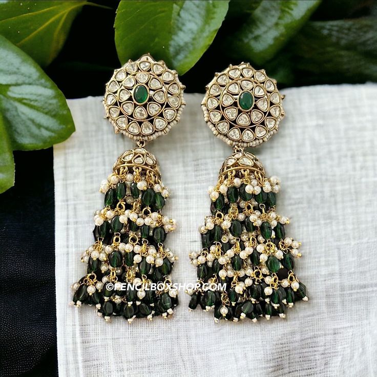 **Kundan Green Moissanite Jhumka Earrings - Elegant Bollywood Wedding Jewelry** Add a touch of timeless elegance to your jewelry collection with these exquisite Kundan Green Moissanite Jhumka Earrings. Perfect for weddings, Bollywood-inspired events, or any festive occasion, these earrings are a stunning example of traditional Indian craftsmanship. **Key Features - **High-Quality Materials Crafted with premium Kundan stones and green moissanite, these earrings offer a radiant sparkle that rivals Green Cutdana Earrings For Wedding, Green Drop Earrings Jhumkas For Diwali, Green Drop Jhumkas For Diwali, Green Tilla Earrings For Wedding, Green Drop Earrings Jhumkas For Festivals, Green Drop Jhumkas For Festivals, Green Kundan Jhumkas Drop Earrings, Green Latkan Bridal Earrings For Diwali, Green Bridal Earrings With Latkans For Diwali