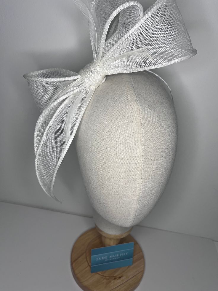 White high-quality sinamay bow attached to coordinating headbands for easy wear. Each fascinator is crafted by hand, ensuring that no two pieces are exactly alike. Our bow design fascinators are available in a variety of colors to match any outfit. Whether you're looking for a bold pop of color or a subtle neutral tone. 🖤This head piece looks simply stunning and is perfect for weddings, special occasions or a day at the races.  🖤All head pieces are finished with matching headband wrapped in co-ordinating silk ribbon or secure millinery elastic which is comfortable and easy hidden. 🖤Shipped in a sturdy (keepsake) box and packed with special love and care.  🖤Made in the UK - customised fascinator orders are welcome. Please send me a message and we can create something unique.  Terms & Co Adjustable Hats With Bow For Wedding, White Summer Ceremony Fascinator, Fitted White Hair Accessories For Weddings, White Formal Bow For Summer, Summer Wedding Fascinator With Ribbon, Adjustable Bow Headpiece For Royal Ascot, Royal Ascot Formal Fascinator With Satin Bow, Kentucky Derby Formal Fascinator With Satin Bow, White Fascinator With Matching Headband For Party