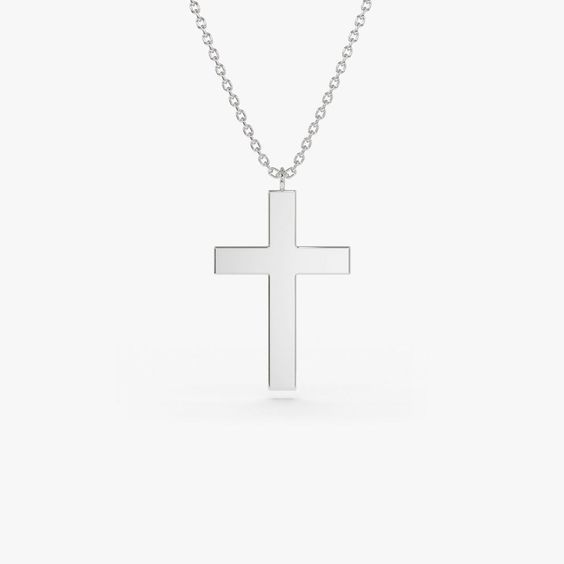 Gold KT: 14K Custom Gold Color: Rose Gold, Yellow Gold, White Gold Cross: 18 x 11 MM This 14k plain gold dangling cross necklace is a simple yet stunning accessory that will add a touch of sophistication to any outfit. The delicate gold chain holds a beautifully crafted cross charm that dances elegantly with every movement. Measuring approximately 18mm in size, this necklace is the perfect size for everyday wear, and the 14k gold construction ensures that it will last for years to come. Minimalist White Crucifix Jewelry, Elegant Everyday Sterling Silver Cross Necklace, Classic Polished Crucifix Cross Necklace, Classic Sterling Silver Cross Necklace For Formal Occasions, Everyday Classic Cross Pendant Necklace, Classic Everyday Cross Pendant Necklace, Classic White Gold Crucifix Necklace, Classic Everyday Cross Necklace, Yellow Gold Sterling Silver Cross Pendant Necklace