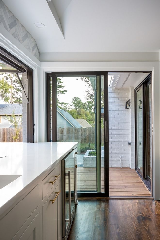 an open kitchen with sliding glass doors leading to the outside