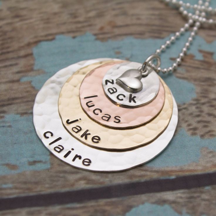 "This is my most popular necklace for mothers, grandmothers, or pet lovers! I begin with a 1/2\" sterling silver disc (9 characters max), then a 3/4\" copper disc (12 character max), a 1\" brass disc(16 character max) and last a 1-1/4\" silver disc (20 character max). All discs are hammered and are personalized with names of your choice. The pendant is topped with a sterling silver heart charm. Hangs from a sterling silver chain. **Please read my store policy about copper and brass jewelry befor Sterling Silver Round Charm Necklaces For Mom, Nickel Free Necklace For Anniversary, Nickel-free Necklace For Anniversary, Nickel-free Round Necklace For Anniversary, Nickel Free Round Charm Necklace For Mom, Nickel-free Round Charm Necklace For Mom, Hand Stamped Round Disc Necklace For Mom, Hand Stamped Round Pendant Necklace For Mom, Hand Stamped Round Pendant Necklace As Gift For Mom