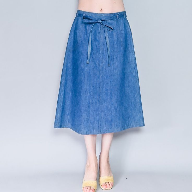 Vintage Blue Midi Wrap Skirt Jean Skirt By Levi's. Waist Tie. Size Waist 34 = L/Xl. Length Appx 29". Condition: New With Tags Attached/ Deadstock Material: 65% Cotton, 35% Polyester Stretch: No Pockets: Yes Lined: No Instagram @Fashionwithouttrashin Model: Height 5’8” Bust 34b Waist 27” Hips 35" Smoke-Free Minimal Packaging Photos Ornamental Stone Llc 2022 Tags: Classic, Cute, Flattering, Summer, Spring, Fall, Date, Party, High-Rise, Jean, High Waist, Tiktok, Designer, Flared, Tiktok Tik Tok, Ra Summer Denim Knee-length Skirt, Chic Non-stretch Blue Denim Skirt, Spring Knee-length Denim Blue Skirt, Chic Knee-length Denim Skirt For Summer, Spring Knee-length Lined Denim Skirt, High Waist Denim Blue Skirt For Spring, Spring Denim Knee-length Skirt, Spring Medium Wash Knee-length Skirt, Knee-length Blue Denim Skirt For Summer