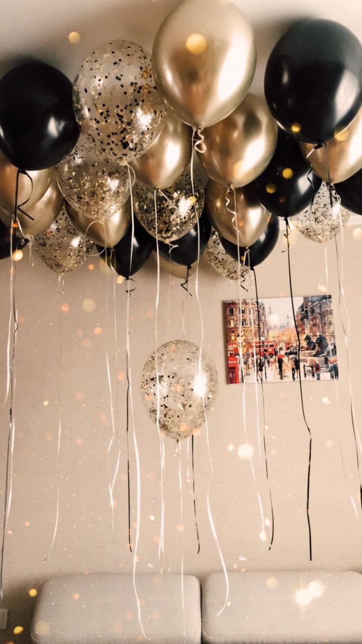 black and gold balloons hanging from the ceiling