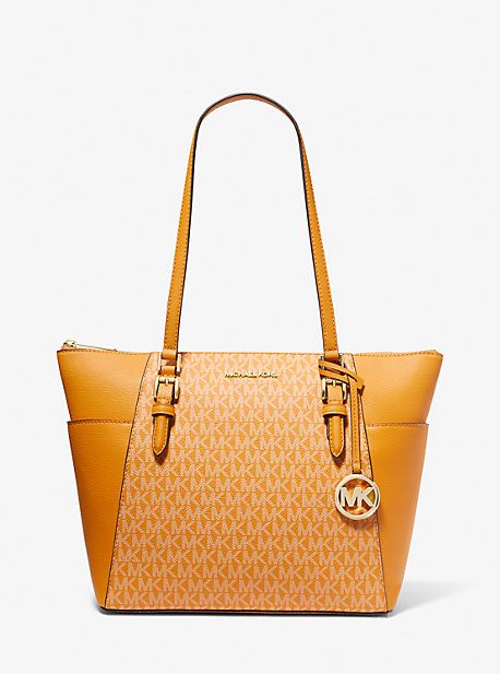 Our signature-print canvas and leather Charlotte tote bag is a timeless addition to your wardrobe. It features two side slip pockets for quick access to your phone and keys while its top-zip fastening opens to a spacious interior that’s designed to hold your essentials for a day at the office—plus a change of clothes for the gym. A detachable charm finishes this carryall with covetable appeal. Travel Tote Bag In Signature Coated Canvas, Travel Bag With Logo And Signature Coated Canvas, Modern Bags With Logo In Coated Canvas, Trendy Coated Canvas Bags With Zipper Closure, Travel Bag With Zipper And Signature Coated Canvas, Shopping Bags With Leather Trim In Signature Coated Canvas, Trendy Bags With Leather Trim And Coated Canvas, Trendy Coated Canvas Bags With Leather Trim, Coated Canvas Satchel With Logo