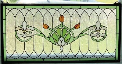 a stained glass window with flowers and leaves on the bottom panel, in front of a house