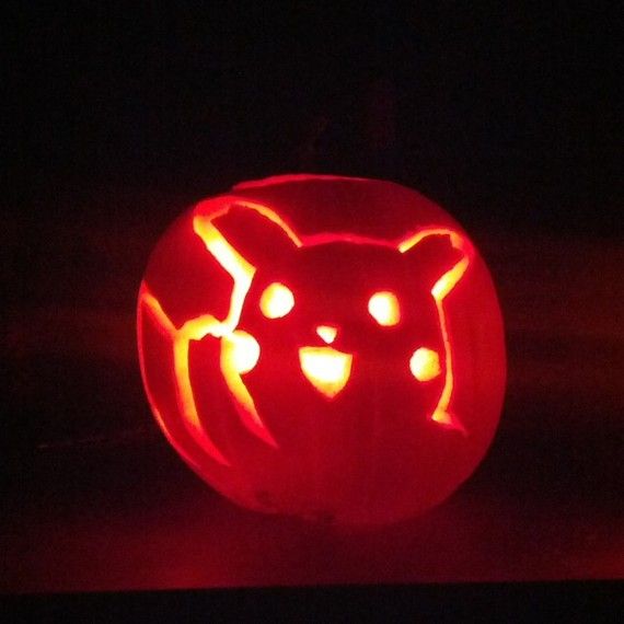 a pumpkin carved to look like a cat with glowing eyes